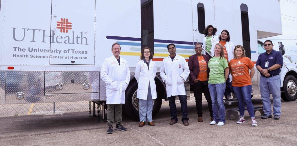 The research team pictured with the mobile unit. (Photo by UTHealth).